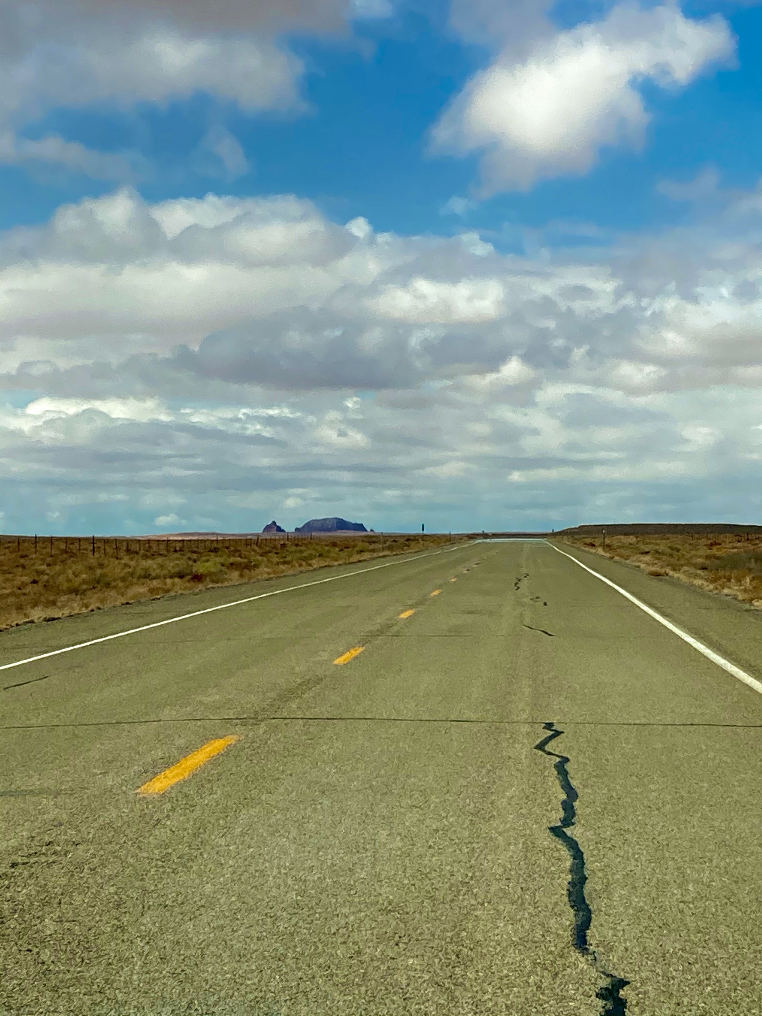straight asphalt road through the desert