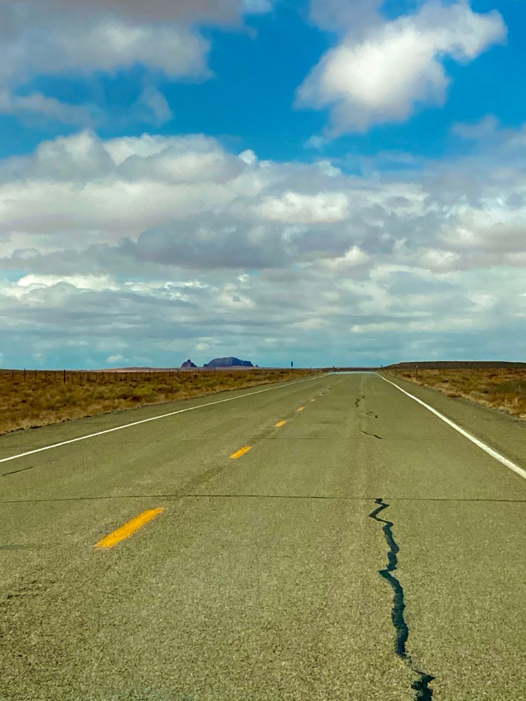 straight asphalt road through the desert