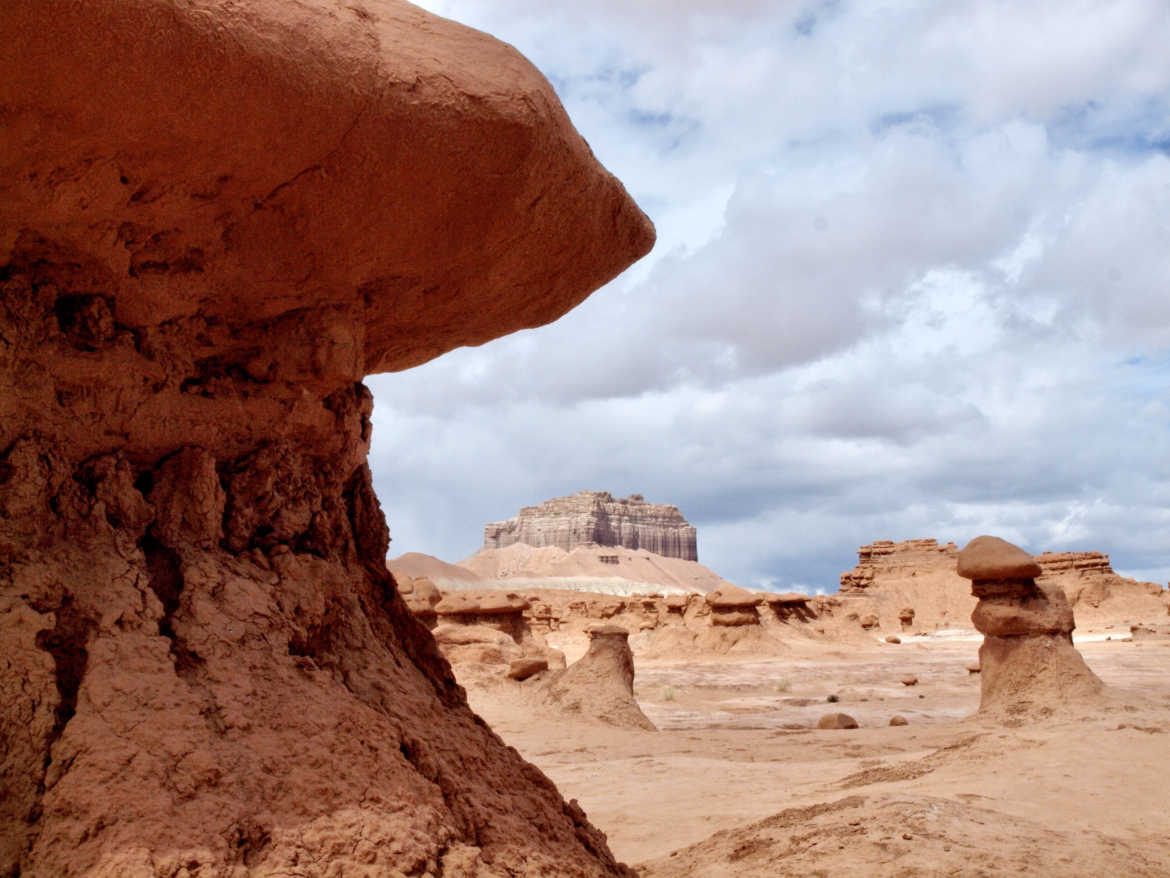 Goblin valley desert hoodoos with Wild Horse Butte in the distance