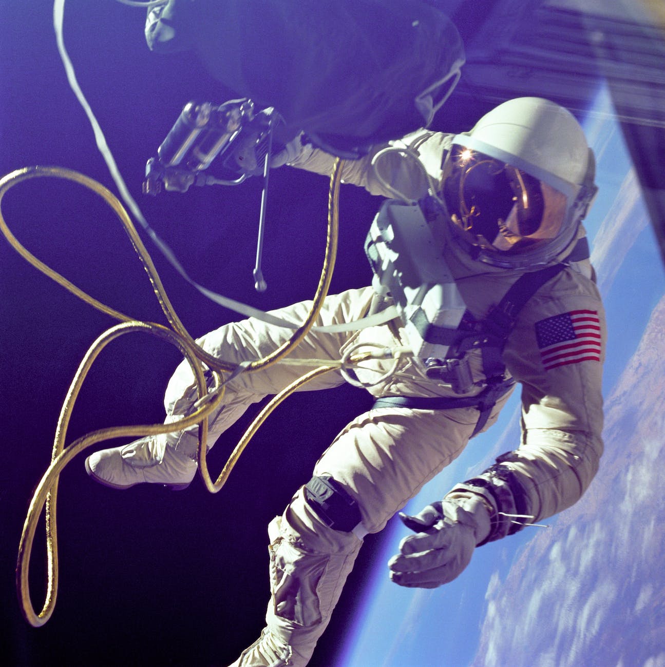 Astronaut on a spacewalk surrounded by umbilical cords